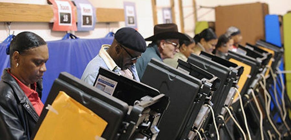 People using voting machines