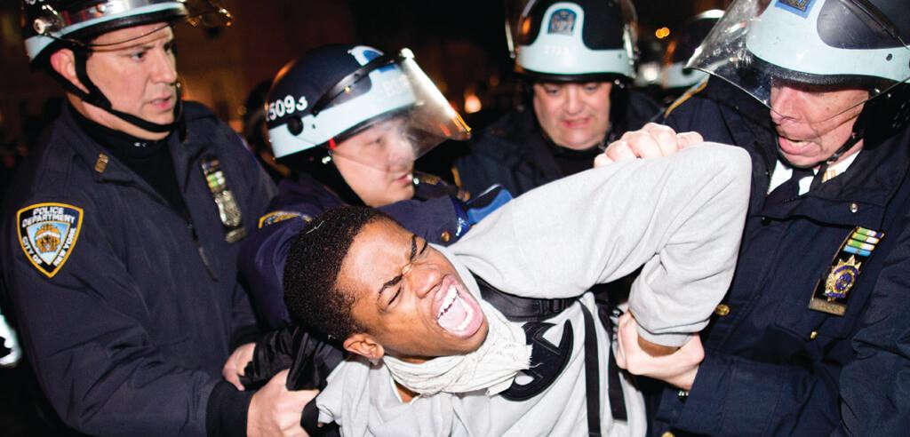 Four white New York City police officers arrest demonstrator during march for 16-year-old Kimani Gray, shot to death by police