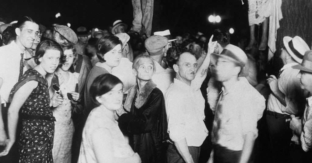 White people pose with hanging corpses of lynching victims Thomas Shipp and Abram Smith in Marion, Indiana.